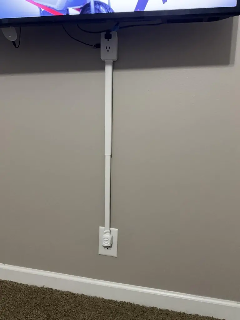 Socketify vertical track powering a wall-mounted TV